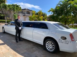 A Man Posing In Front Of White Limo